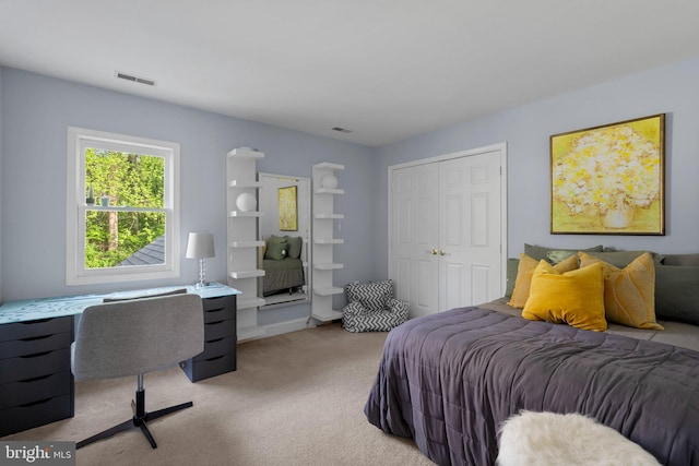 bedroom with visible vents, carpet flooring, and a closet