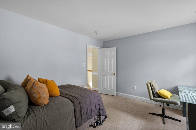 bedroom featuring carpet and baseboards