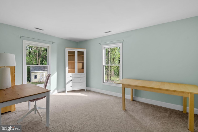 unfurnished office with visible vents, carpet floors, and baseboards