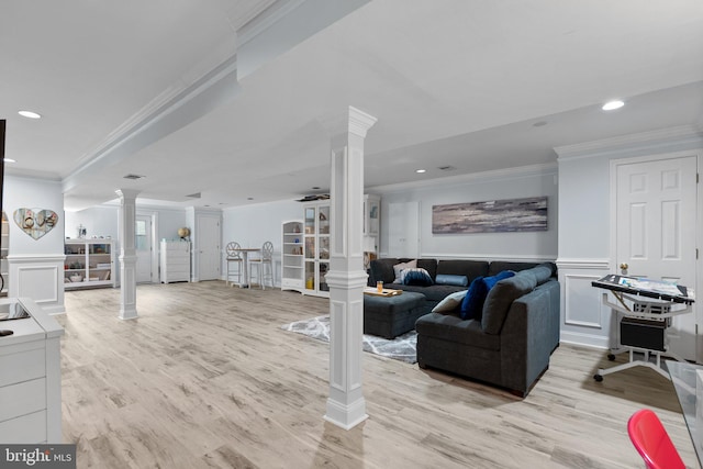 living room featuring ornamental molding, recessed lighting, decorative columns, and a decorative wall