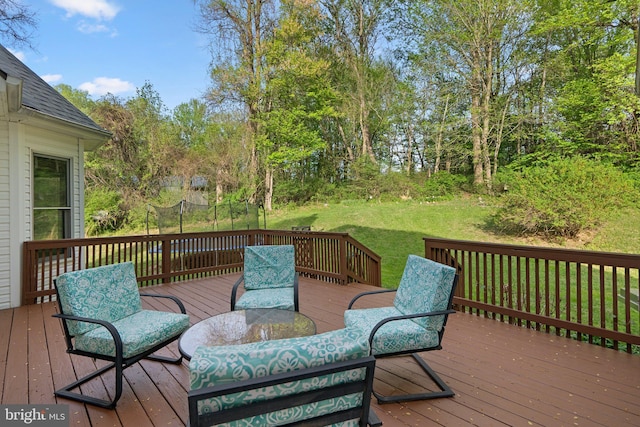 wooden terrace featuring a yard