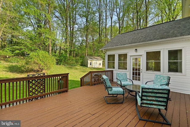 wooden deck with an outbuilding and a lawn