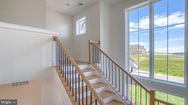 staircase featuring visible vents
