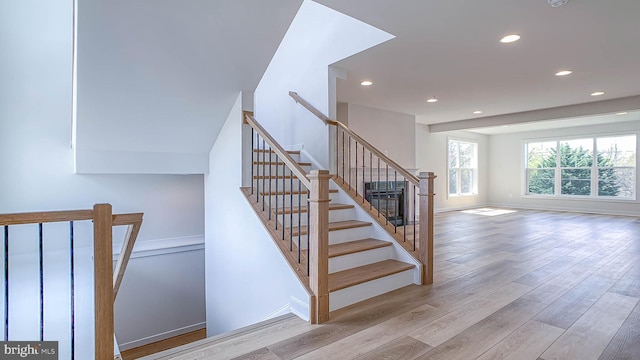 stairs with recessed lighting, baseboards, and wood finished floors