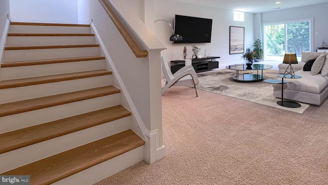 stairway with recessed lighting and carpet