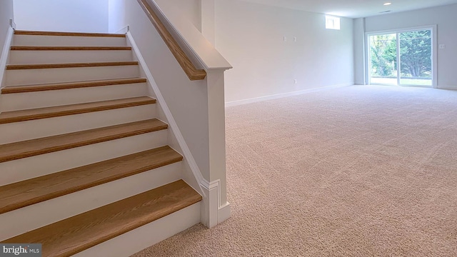 staircase with carpet floors, recessed lighting, and baseboards