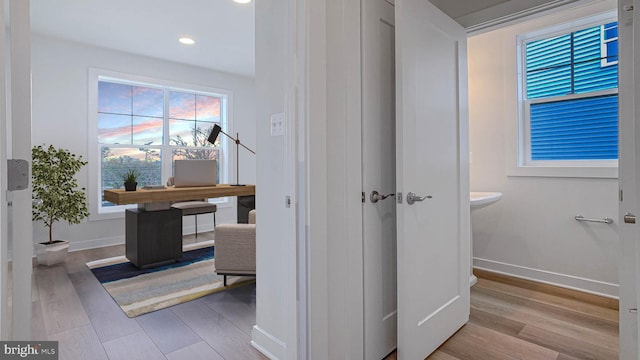 corridor with recessed lighting, baseboards, and wood finished floors