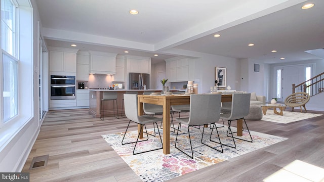 dining area with recessed lighting, visible vents, plenty of natural light, and light wood-type flooring