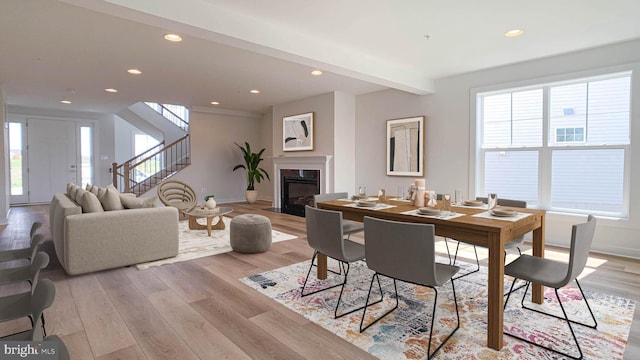 dining area with recessed lighting, baseboards, stairway, and light wood-type flooring