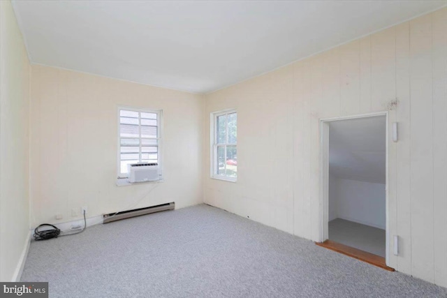 unfurnished bedroom with cooling unit, carpet, and a baseboard radiator