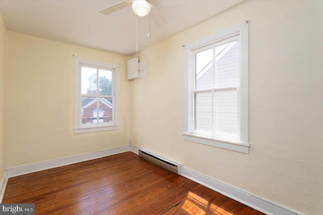 unfurnished dining area with ceiling fan, baseboards, a baseboard radiator, and dark wood finished floors