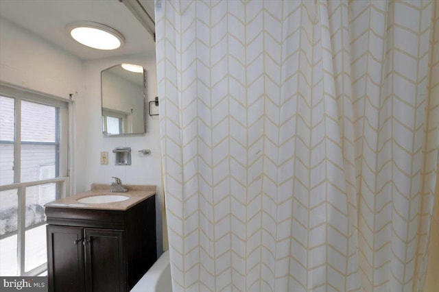 full bath featuring vanity and a shower
