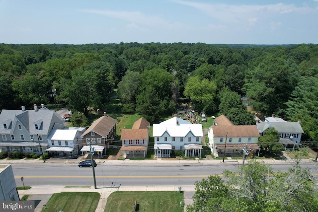 aerial view featuring a forest view and a residential view