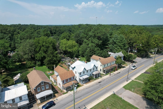 birds eye view of property with a forest view
