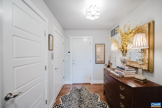 entryway with baseboards and wood finished floors