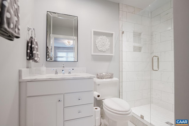 full bathroom featuring toilet, vanity, and a stall shower