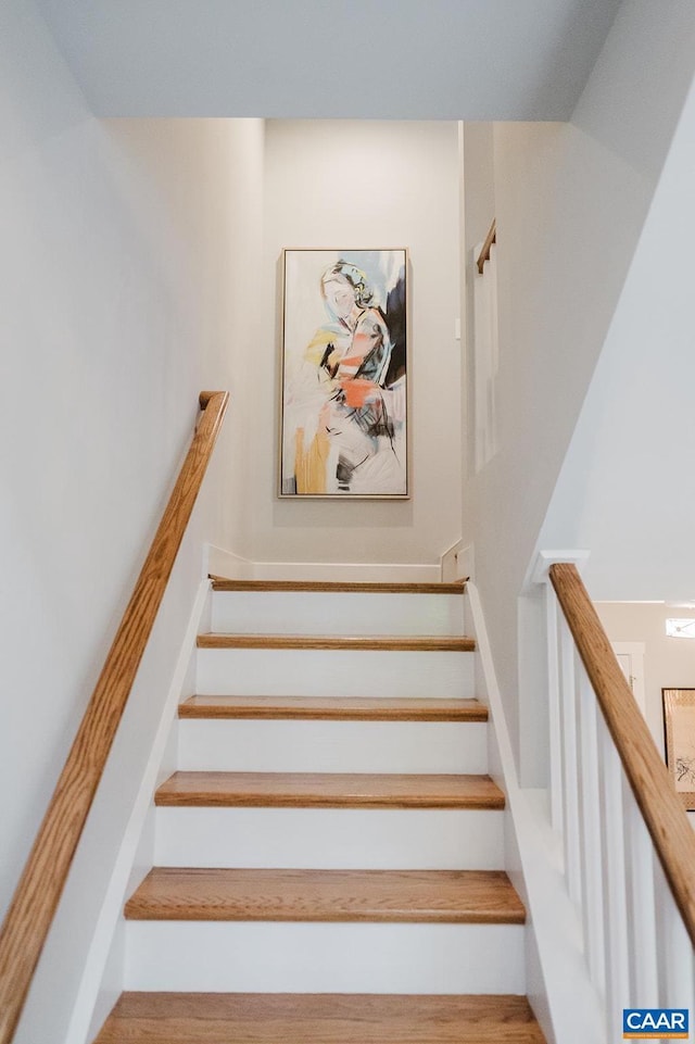 stairs featuring wood finished floors