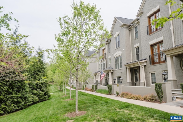 view of home's community with a lawn and a residential view