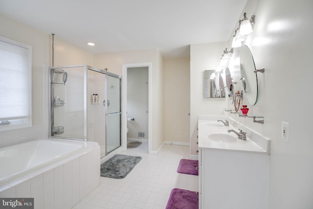 full bath with a stall shower, a sink, tile patterned flooring, and a garden tub