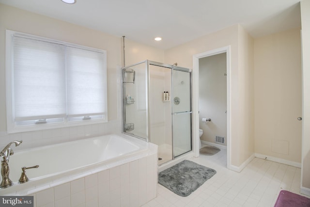 bathroom featuring a stall shower, toilet, a bath, and visible vents