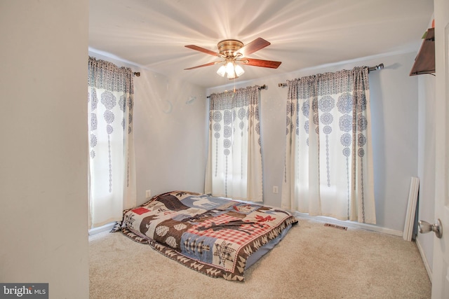bedroom with ceiling fan, carpet flooring, and visible vents