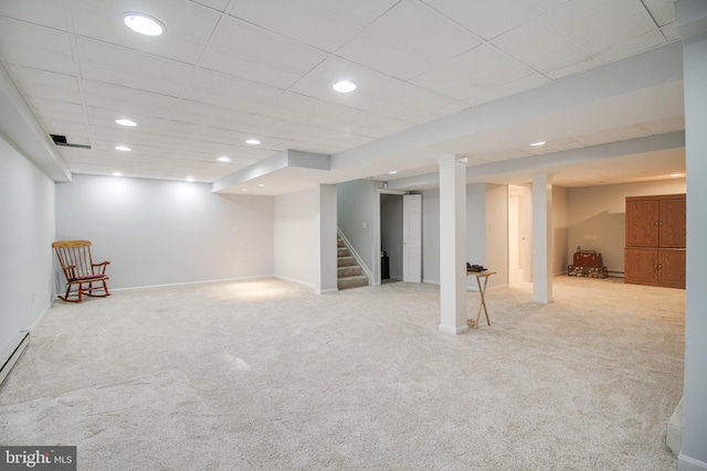 finished below grade area with baseboards, carpet, recessed lighting, and stairs