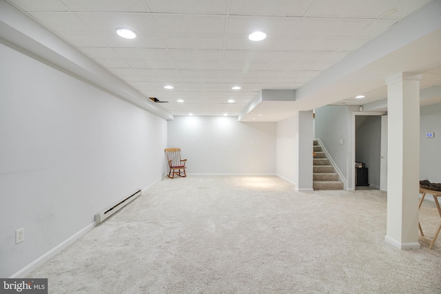 finished below grade area featuring carpet floors, recessed lighting, a baseboard heating unit, and stairway