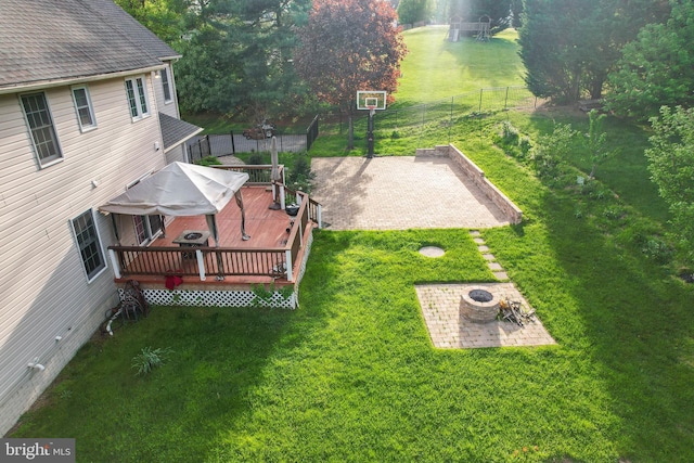view of yard with a patio, fence, and a wooden deck