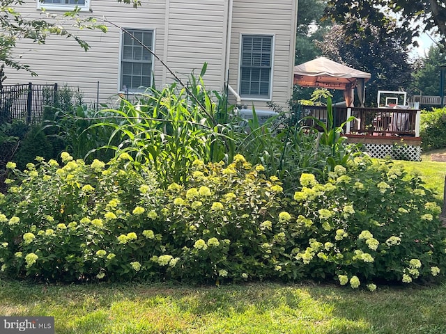 view of yard featuring a gazebo, a wooden deck, and fence