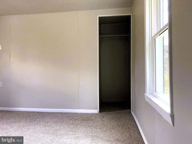unfurnished bedroom with baseboards and carpet floors