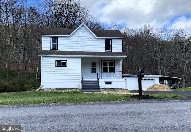 view of front of property with roof with shingles, a garage, driveway, and covered porch