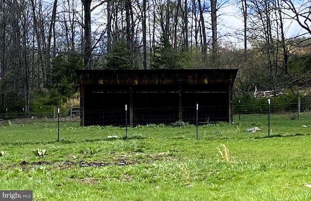 view of pole building with fence