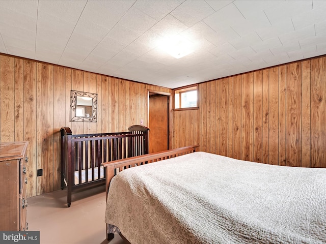 bedroom featuring wooden walls