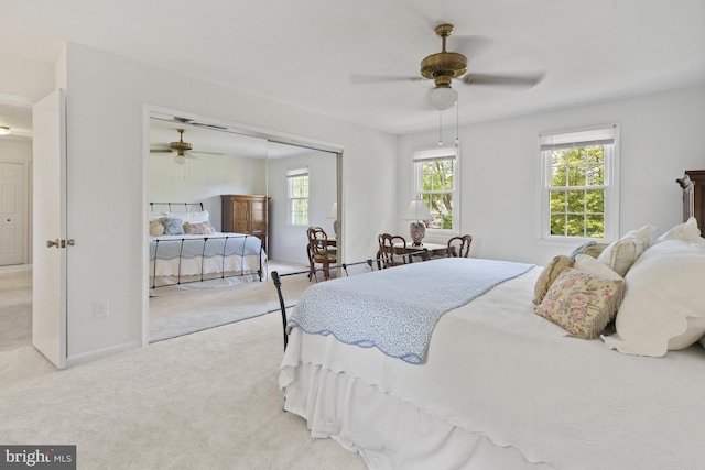 carpeted bedroom with baseboards, a ceiling fan, and a closet
