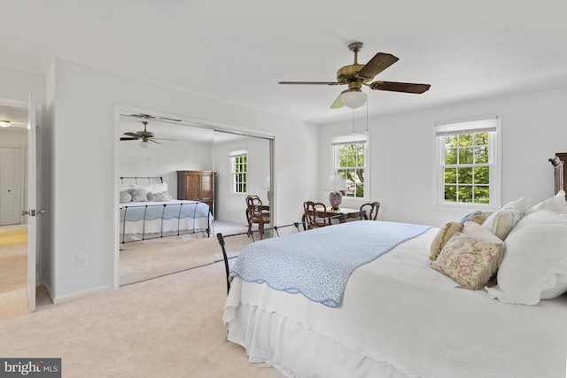 carpeted bedroom featuring a closet, a ceiling fan, and baseboards