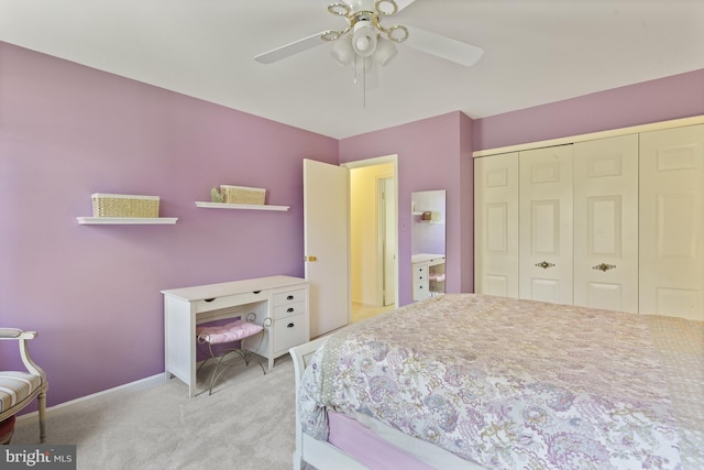 carpeted bedroom with ceiling fan, baseboards, and a closet