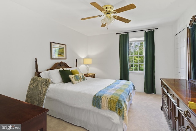 bedroom featuring light colored carpet and ceiling fan