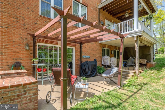 view of patio / terrace with ceiling fan and a balcony