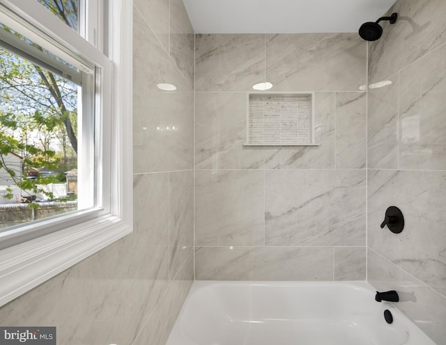 full bathroom featuring shower / bathtub combination and a healthy amount of sunlight