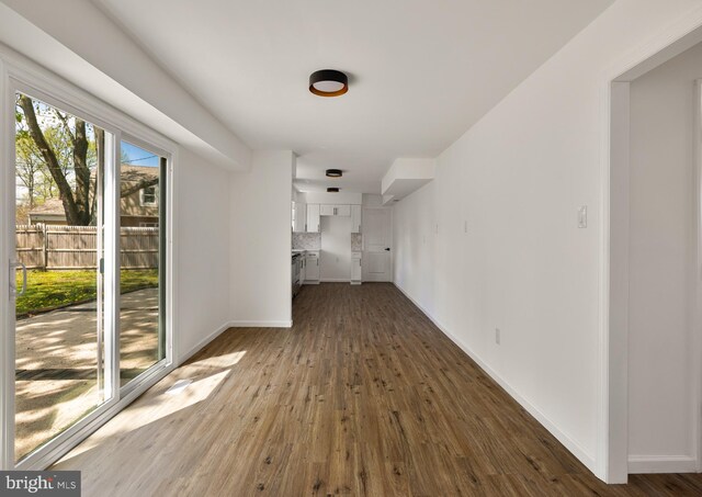 interior space with baseboards and wood finished floors