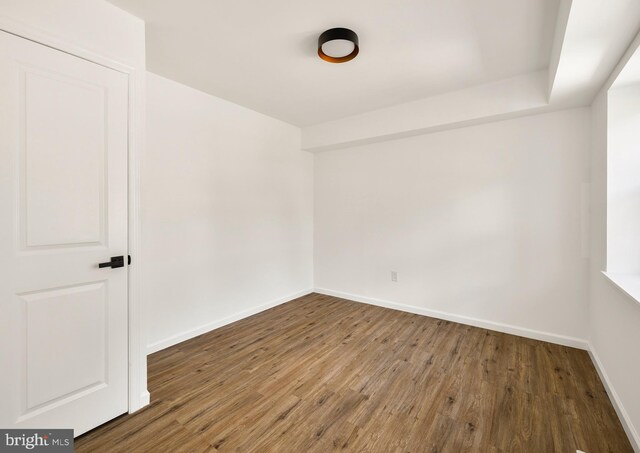 unfurnished room with wood finished floors and baseboards