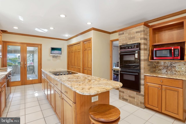 kitchen with black appliances, french doors, light tile patterned flooring, recessed lighting, and a kitchen island