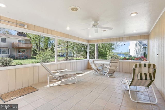 sunroom featuring ceiling fan