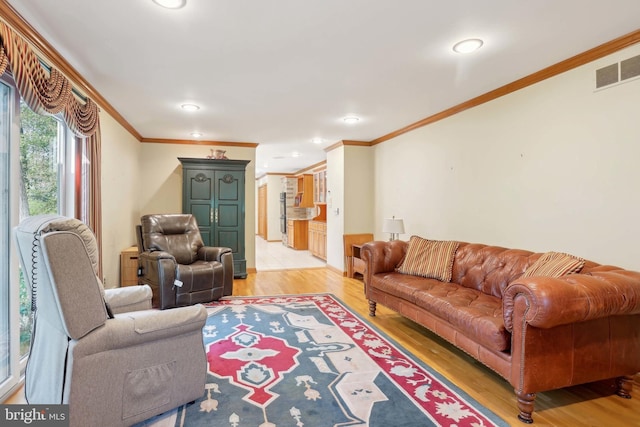 living room featuring crown molding, light wood finished floors, and recessed lighting
