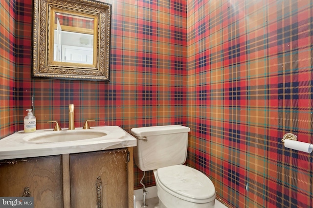 bathroom featuring toilet and vanity
