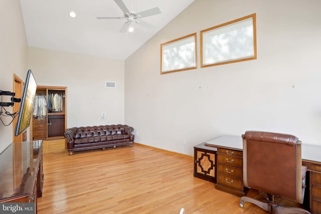 office featuring lofted ceiling, ceiling fan, light wood-type flooring, and baseboards