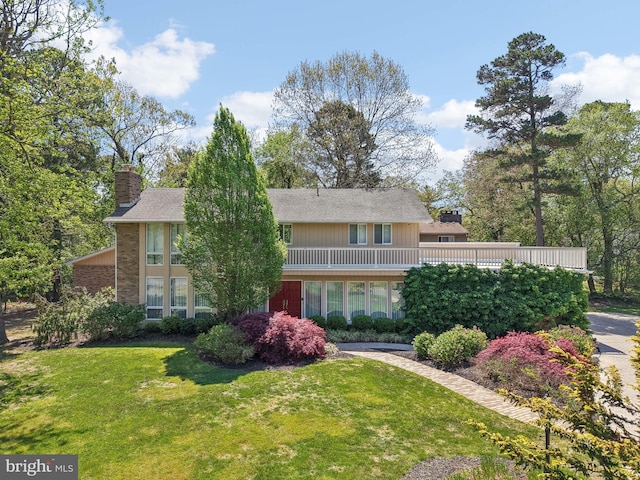 view of front of property featuring a chimney and a front lawn