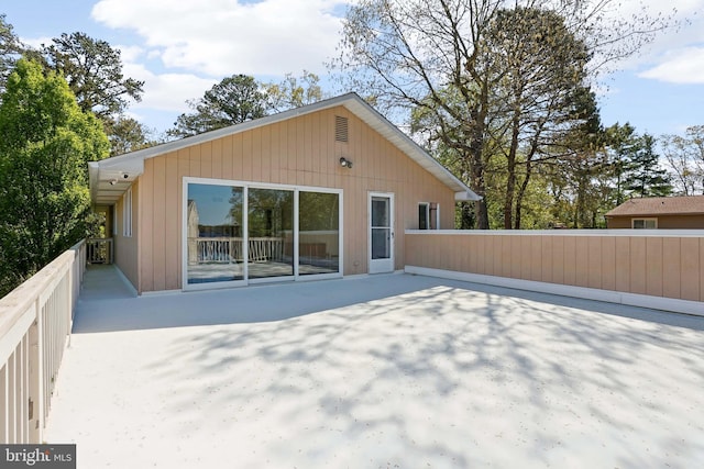 rear view of house featuring a patio area and fence