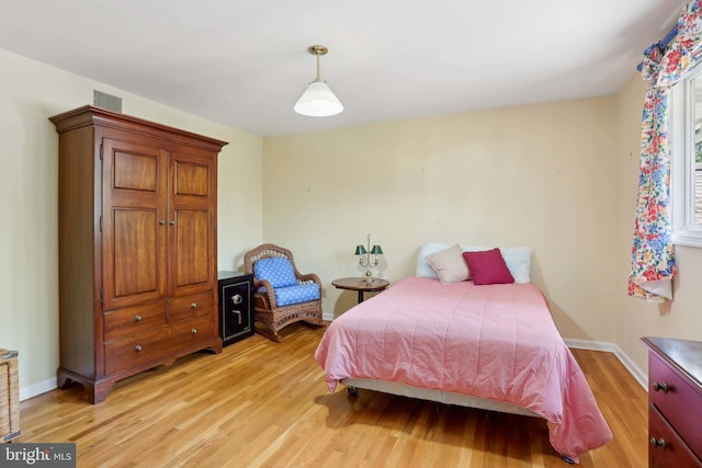 bedroom featuring light wood-style flooring and baseboards