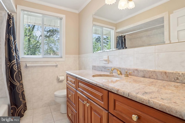 full bathroom featuring vanity, tile patterned flooring, crown molding, toilet, and tile walls